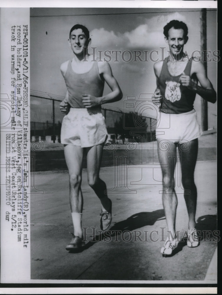 1956 Press Photo Ron Delany and John Landy Jog in Ratcliffe Stadium Fresno - Historic Images