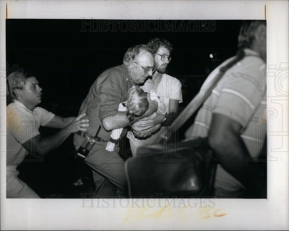 1989 Press Photo Child to an ambulance Detroit River - DFPD72679- Historic Images