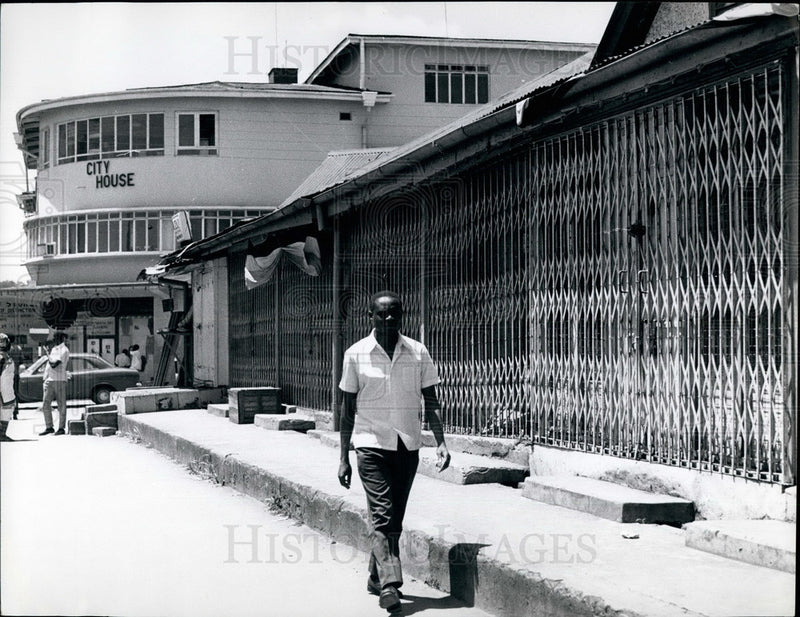 Load image into Gallery viewer, Press Photo Man Walks Past Closed Asian Shop - KSB27551
