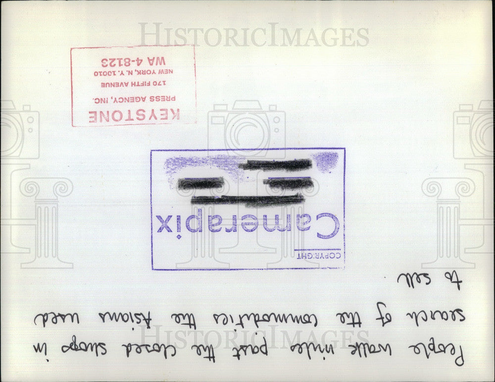 Press Photo Man Walks Past Closed Asian Shop - KSB27551