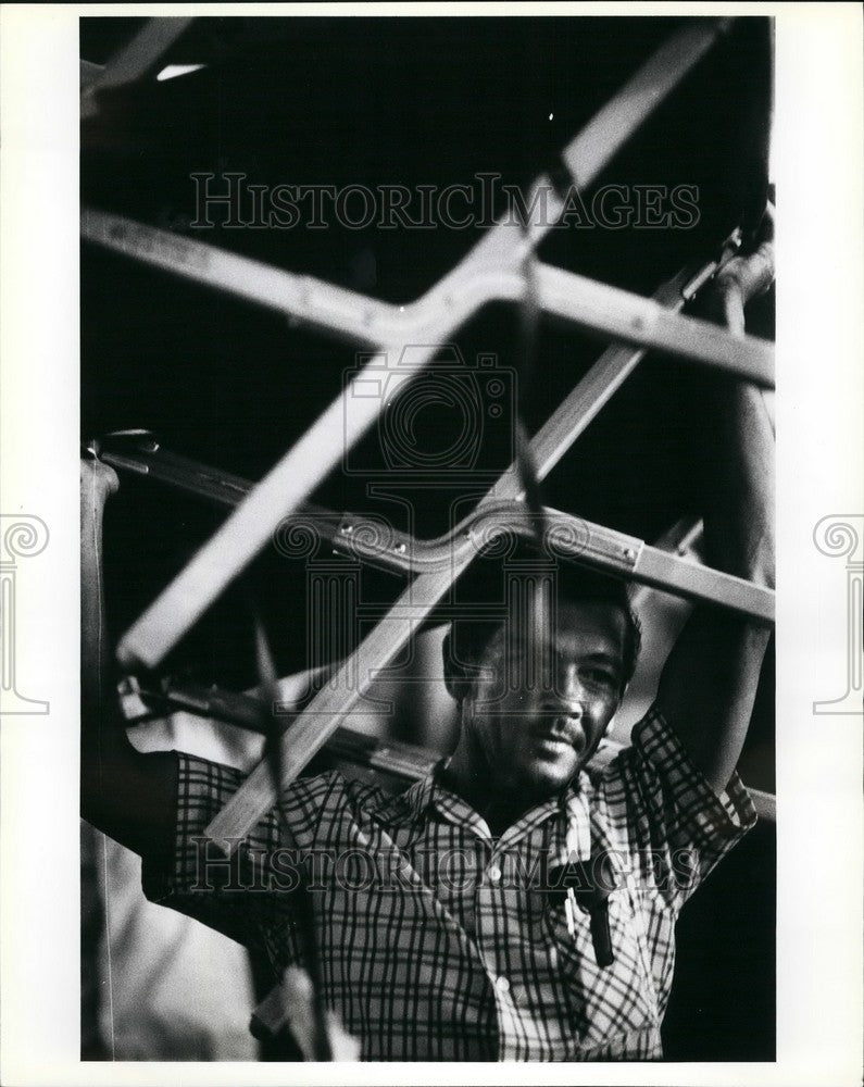 Press Photo A cuban refugee moves a cot to his assigned area in the holding