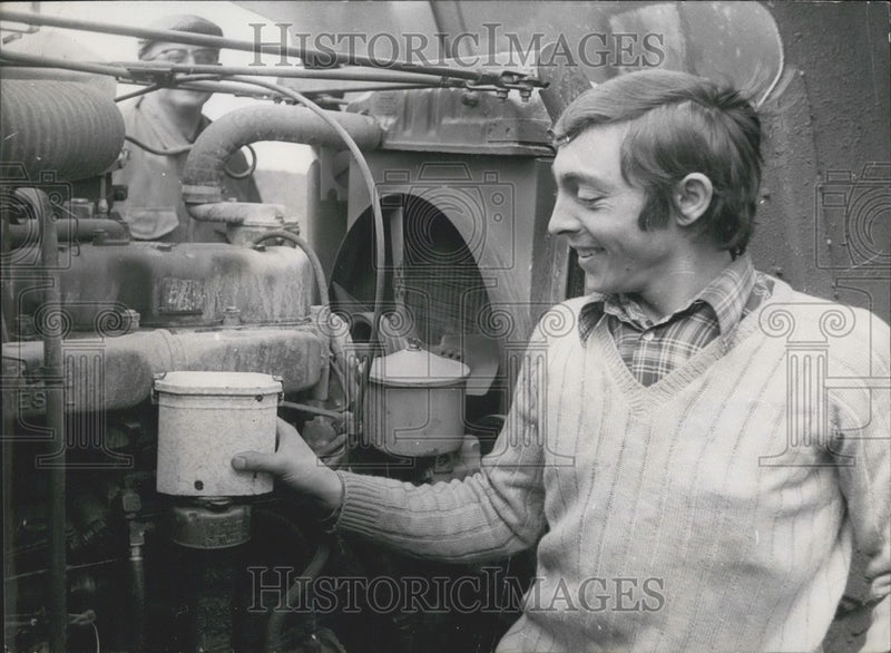 Load image into Gallery viewer, 1971 Press Photo A Truck Driver Warming Lunch on Truck Motor
