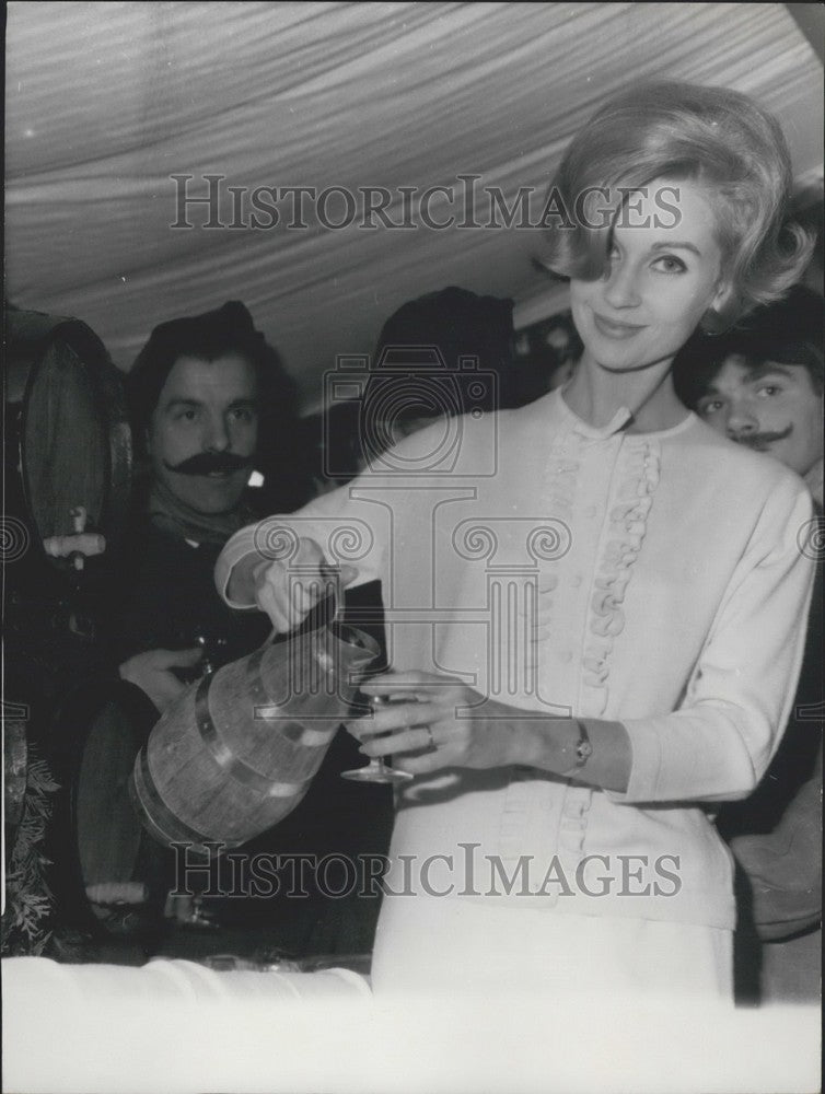 1962 Press Photo Model Wearing Timwear Knit Ruffled Sweater Pours Water Glass