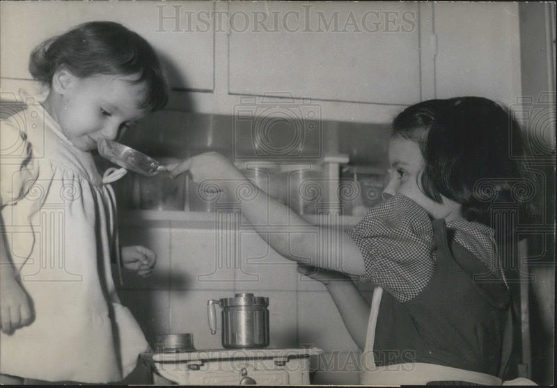Load image into Gallery viewer, 1957 Press Photo Little Girls Playing in a Toy Kitchen

