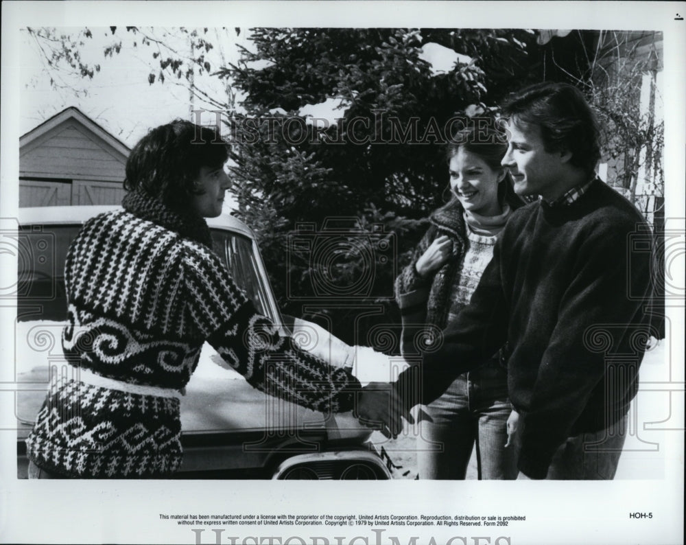 1979 Press Photo Movie two males shaking hands while girl watches by car- Historic Images