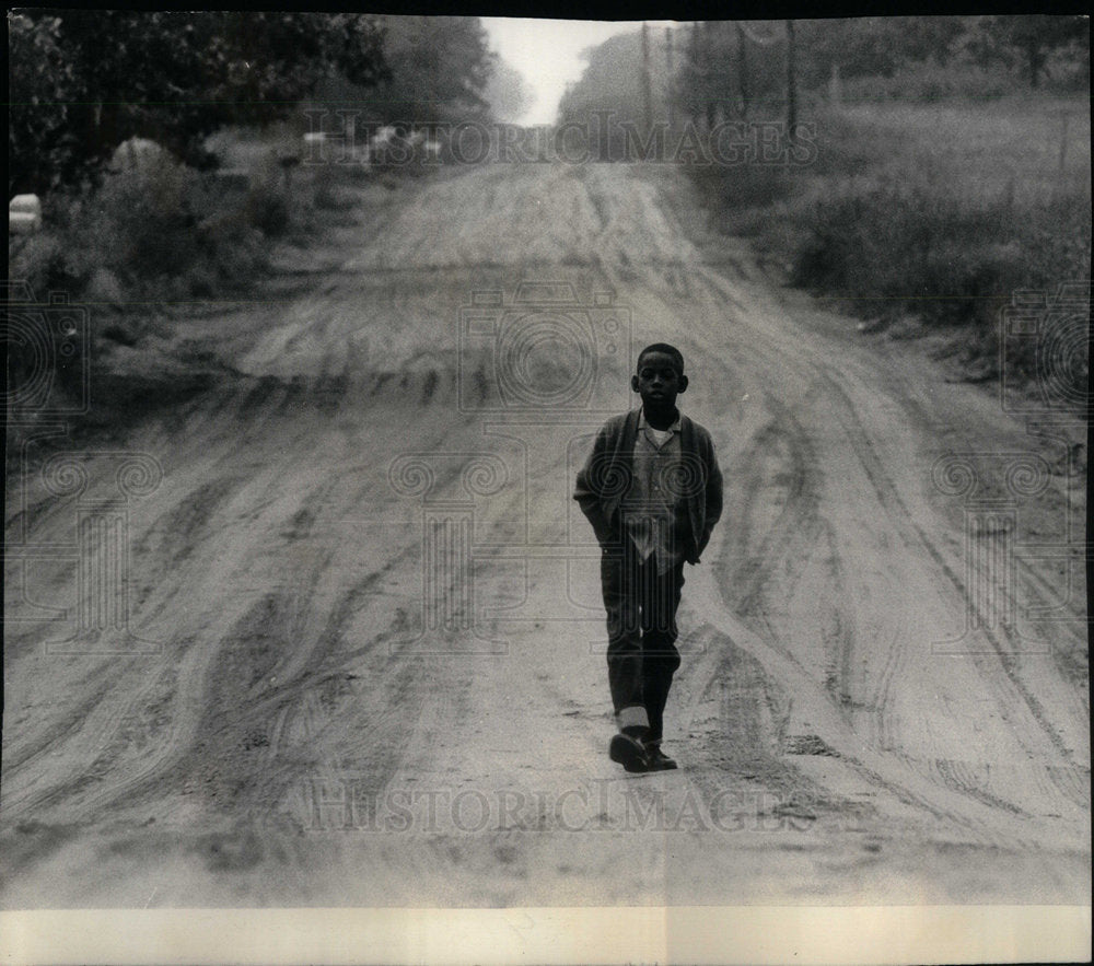 1966 Press Photo Young Boy Walking Alone On Dirt Road - RRX00913- Historic Images