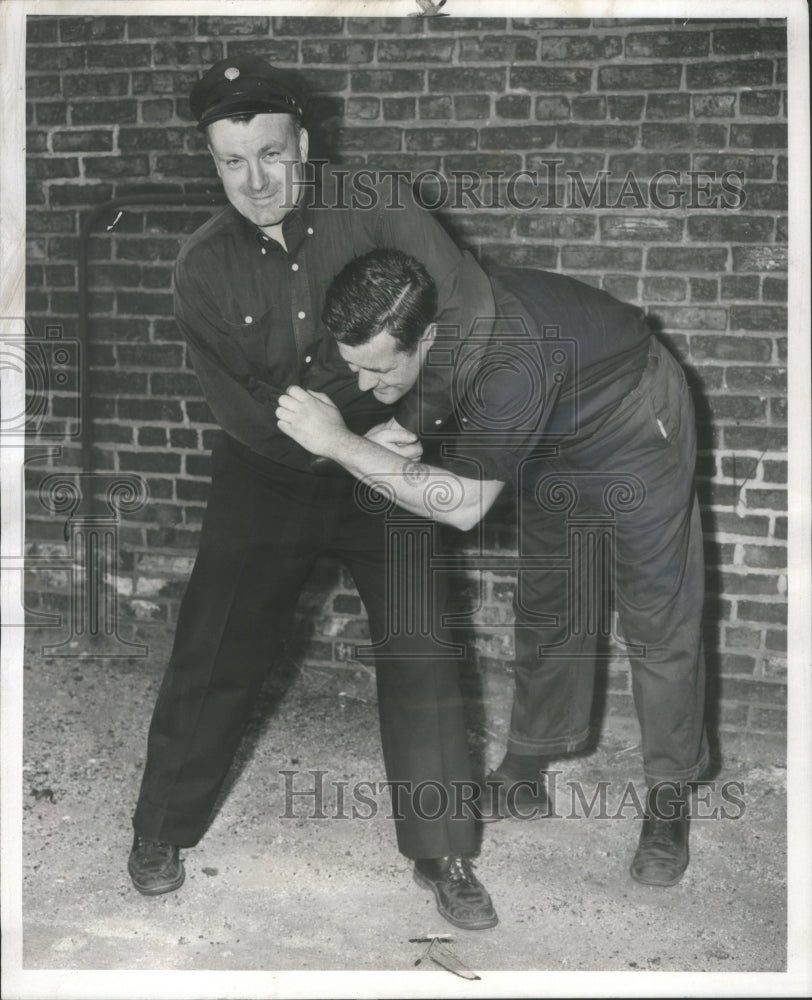 1956 Press Photo Fireman Demonstrating Thief Arrest- RSA40529- Historic Images