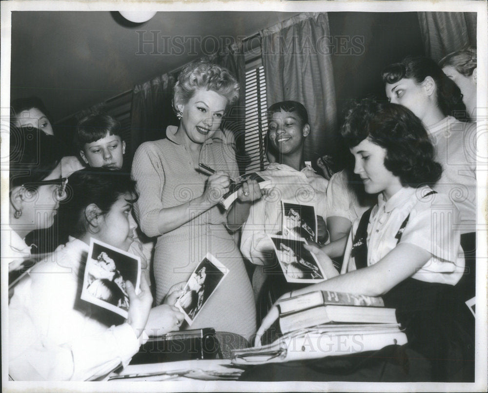 1957 Press Photo Gale Robbins singer signs autographs students High School