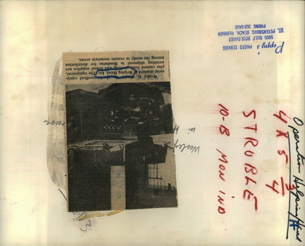 Press Photo Wesley, sorting through donated items at Helping Hand, Inc.