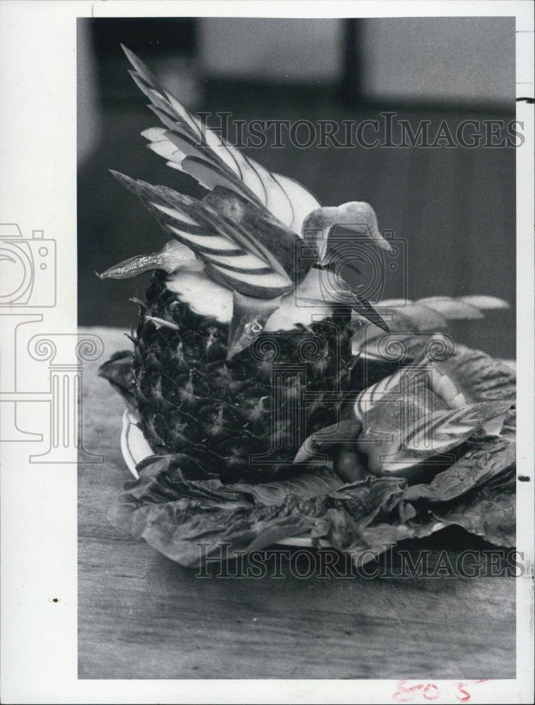 1977PressPhoto The carrot palm tree(L) & apple bird of paradise on its pineapple