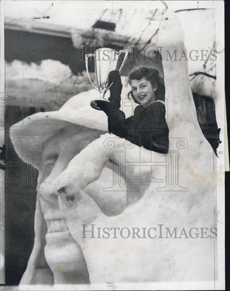 1948 Press Photo Miss Joan Parr, Carnival Queen, sits on the winning sculpture.- Historic Images