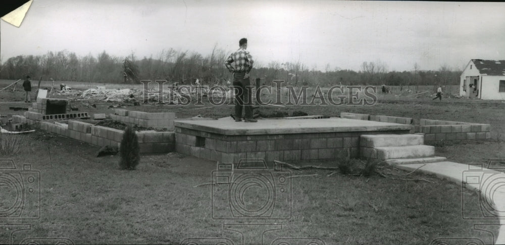 1957 Press Photo E.C. Jeffers surveys tornado damage to home, Falkville, Alabama- Historic Images