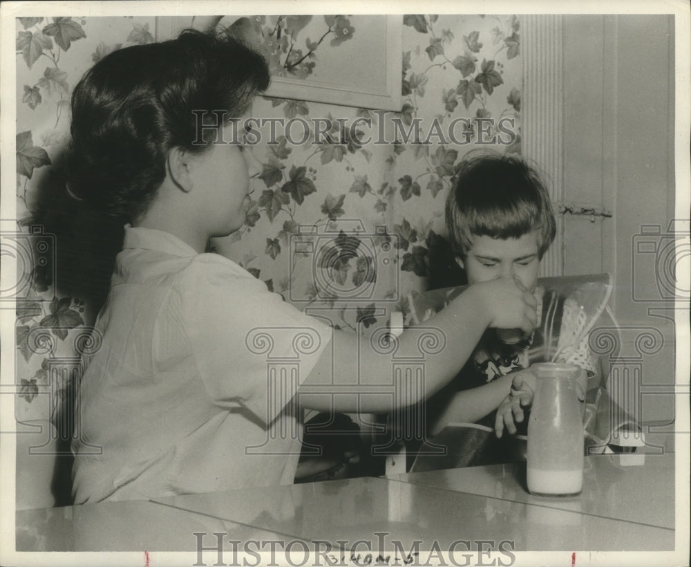 1956 Press Photo Jane Riddle helps Valorie with milk at School for Blind - Historic Images