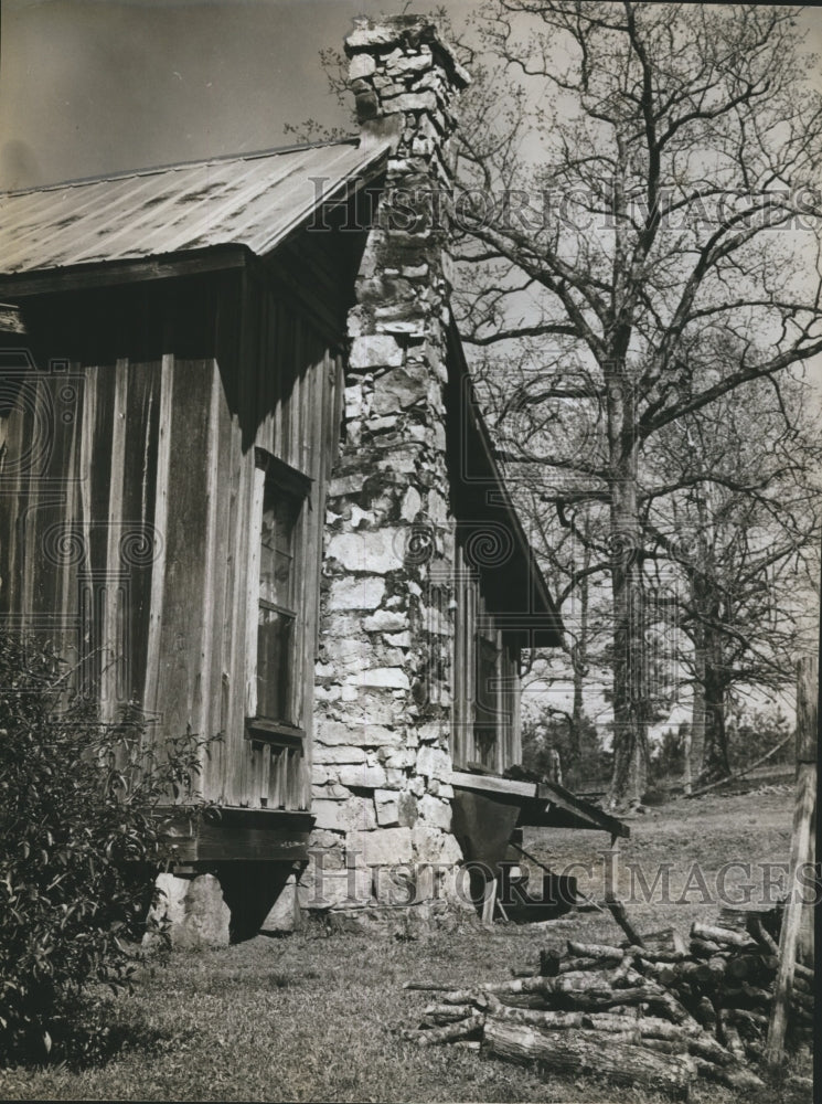 1961 Press Photo Firewood stacked by chimney made of stone and mud- Historic Images