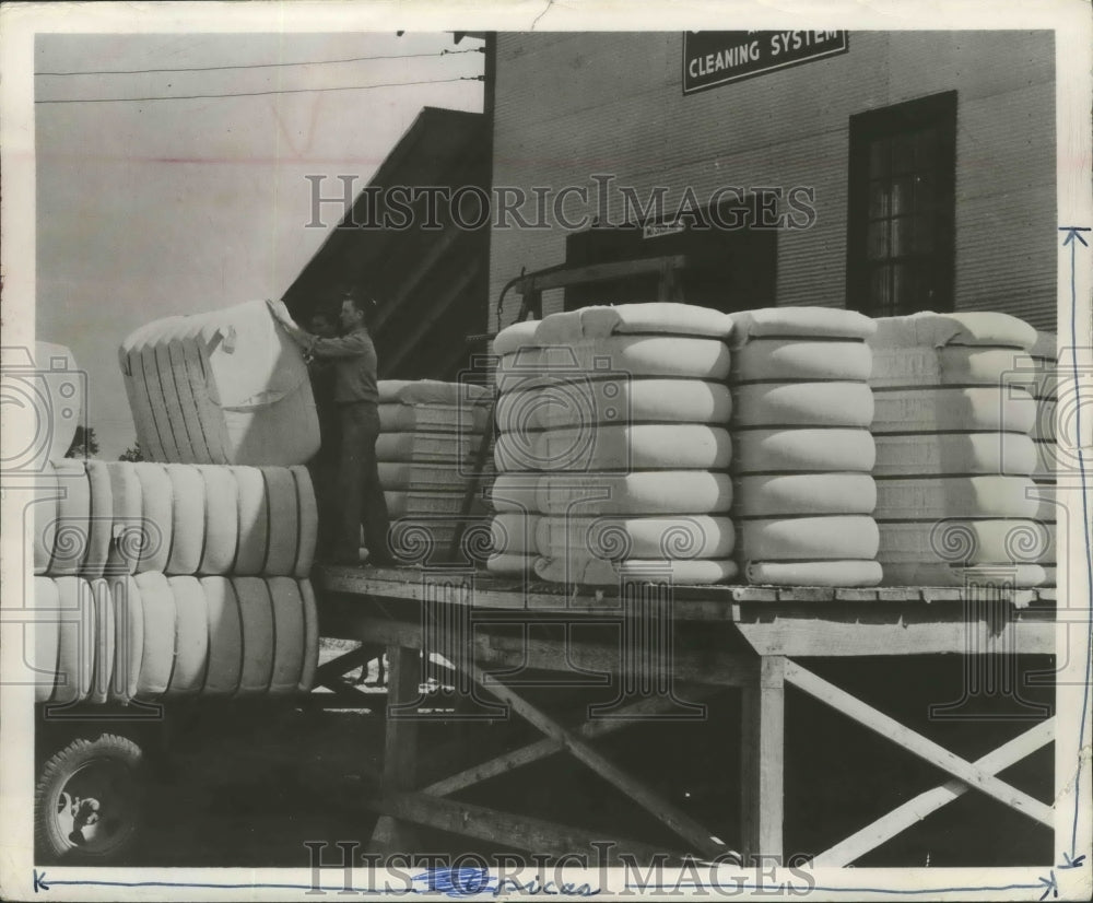 Press Photo Bundles of cotton being loaded onto a truck in Birmingham, Alabama - Historic Images