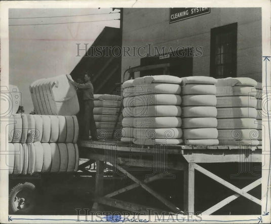 Press Photo Bundles of cotton being loaded onto a truck in Birmingham, Alabama - Historic Images