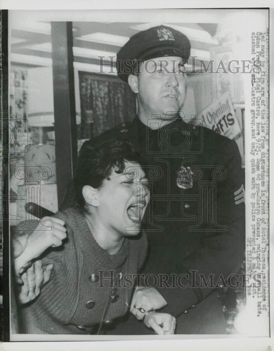 1960 Press Photo NY Policeman restrains a Cuban woman during anti-Castro clash - Historic Images