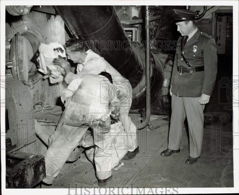 1957 Press Photo Workmen And Guard Dispose Of Ford Styling Center Materials - Historic Images