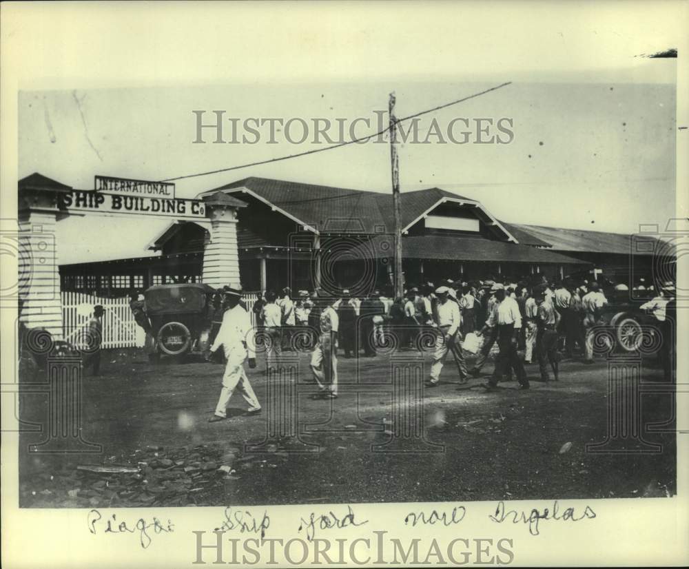 Press Photo Workers &amp; men walking in front of International Ship Building Co.- Historic Images