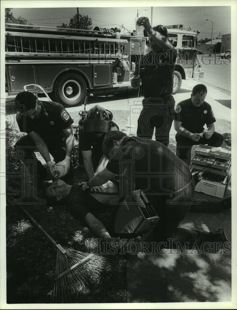 1990 Press Photo Firefighters check supplies by fire truck in Alabama - Historic Images