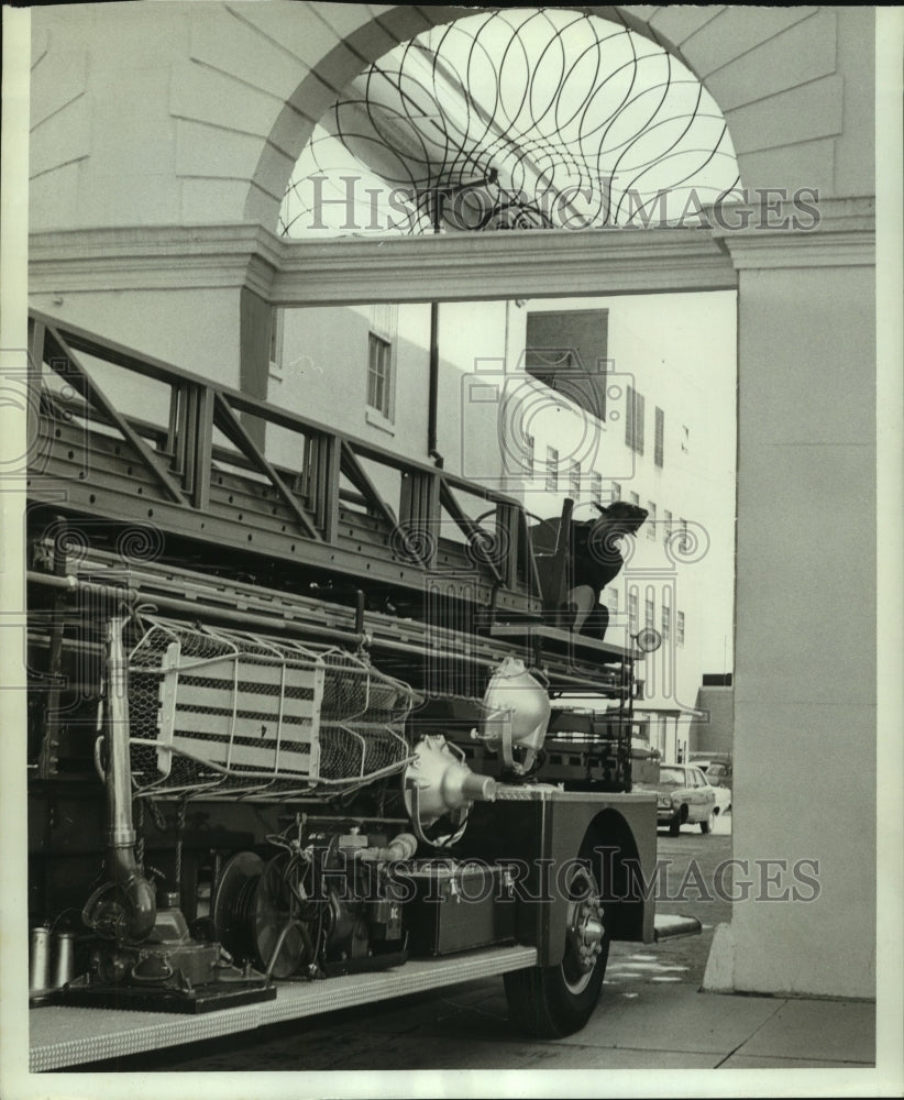 1969 Press Photo Firefighter Matt Sloan atop truck in fire station in Alabama- Historic Images