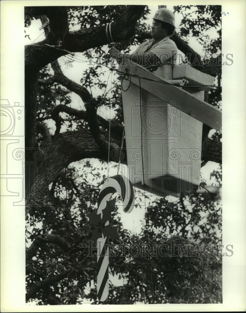 1987 Press Photo Workers Hangs Christmas Decoration in Bienville Square, Mobile- Historic Images