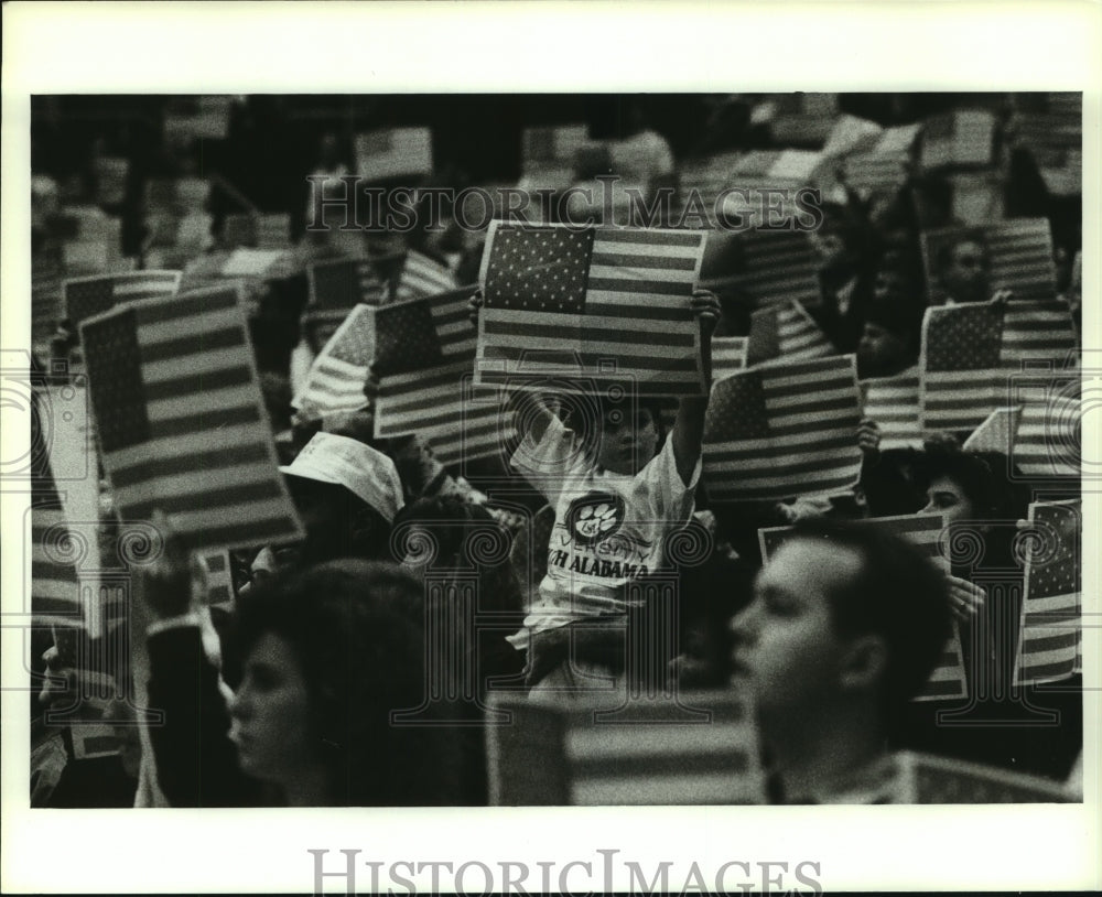 1991 Press Photo Citizens Holding Up Flags at Event, Alabama- Historic Images