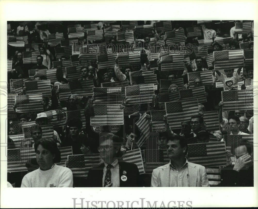 1991 Press Photo Citizens Holding Up Flags at Event, Alabama- Historic Images