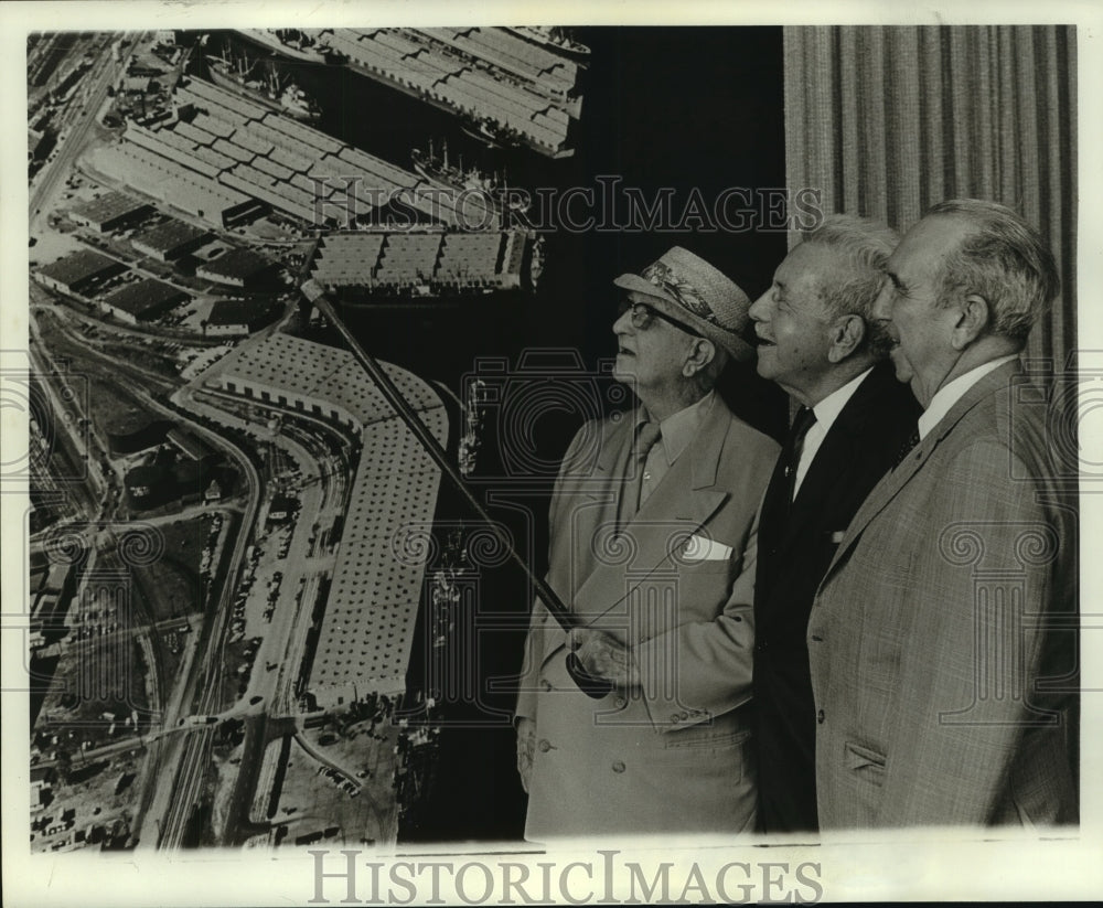 Press Photo Group studying aerial view of Mobile Waterfront, Alabama- Historic Images