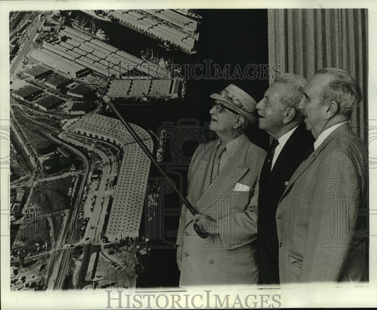 Press Photo Group studying aerial view of Mobile Waterfront, Alabama- Historic Images