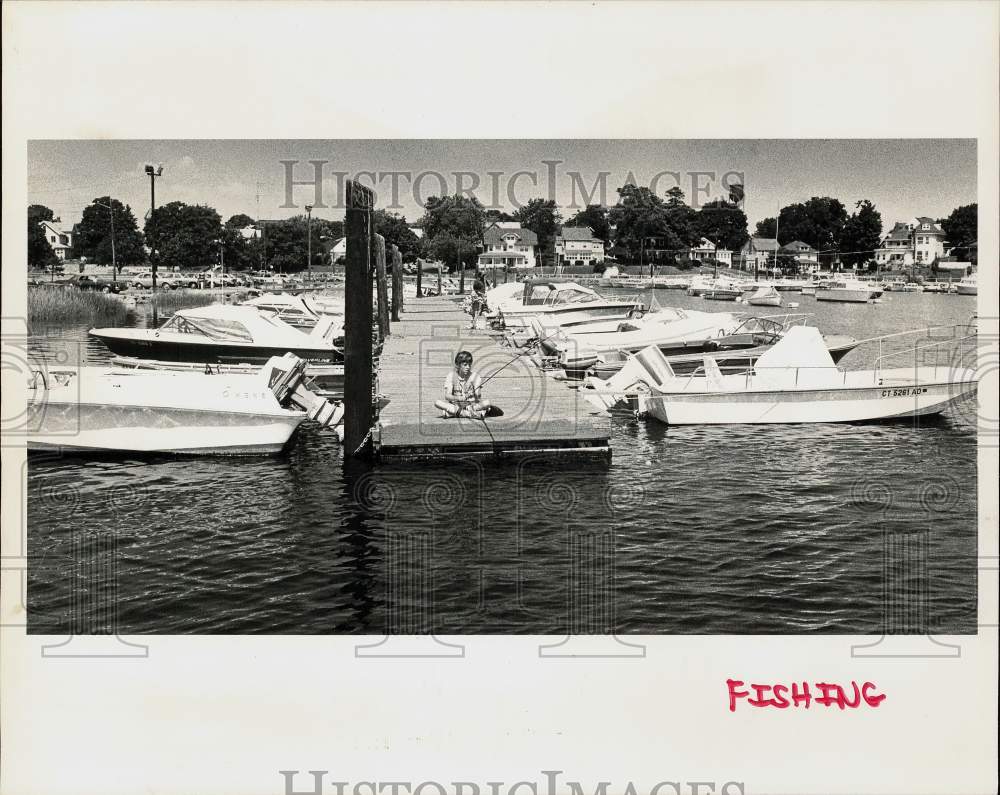 Press Photo Jason Miller fishes off Veteran's Park Dock in Norwalk, Connecticut- Historic Images