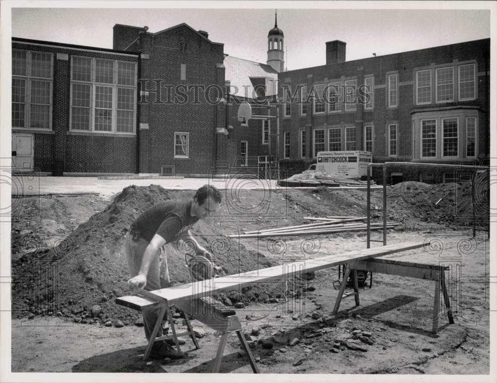 1991 Press Photo Carpenter Mark Tasca cuts lumber at Hamilton School playground- Historic Images