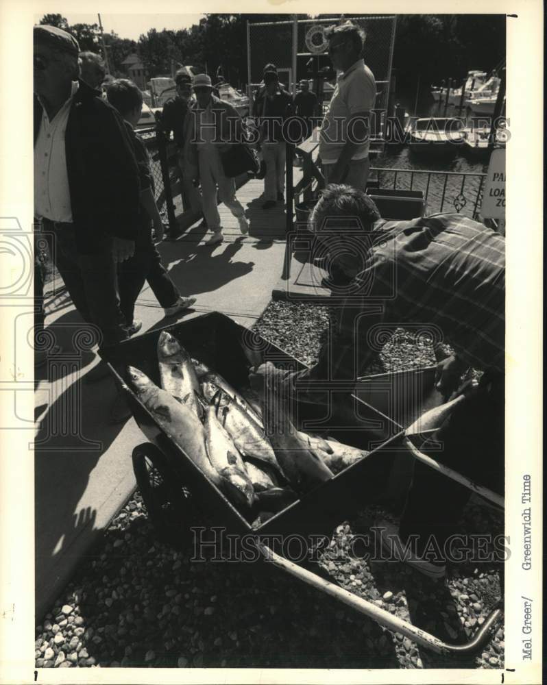 Press Photo A man loads catch from a day of fishing - ctga02741- Historic Images