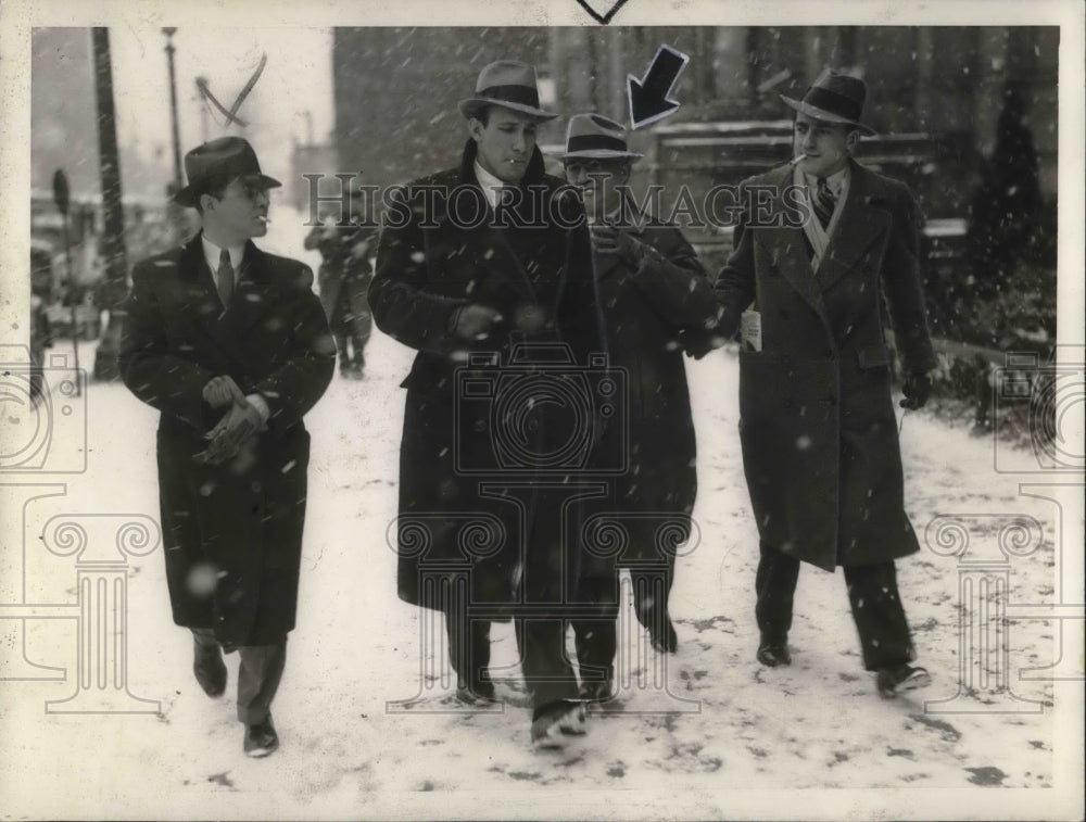 1933 Press Photo Henry A. Belerman tries to hide from cameraman.- Historic Images