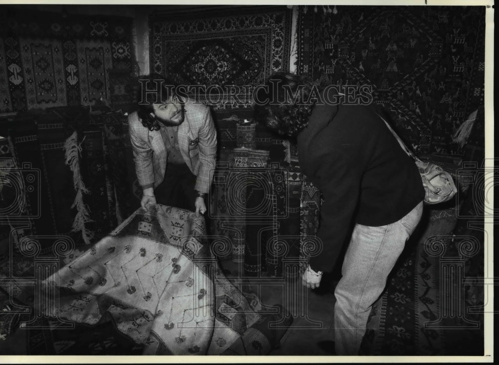 1990 Press Photo Tourists examine a Turkish carpet at Istanbul, Turkey Bazaar- Historic Images