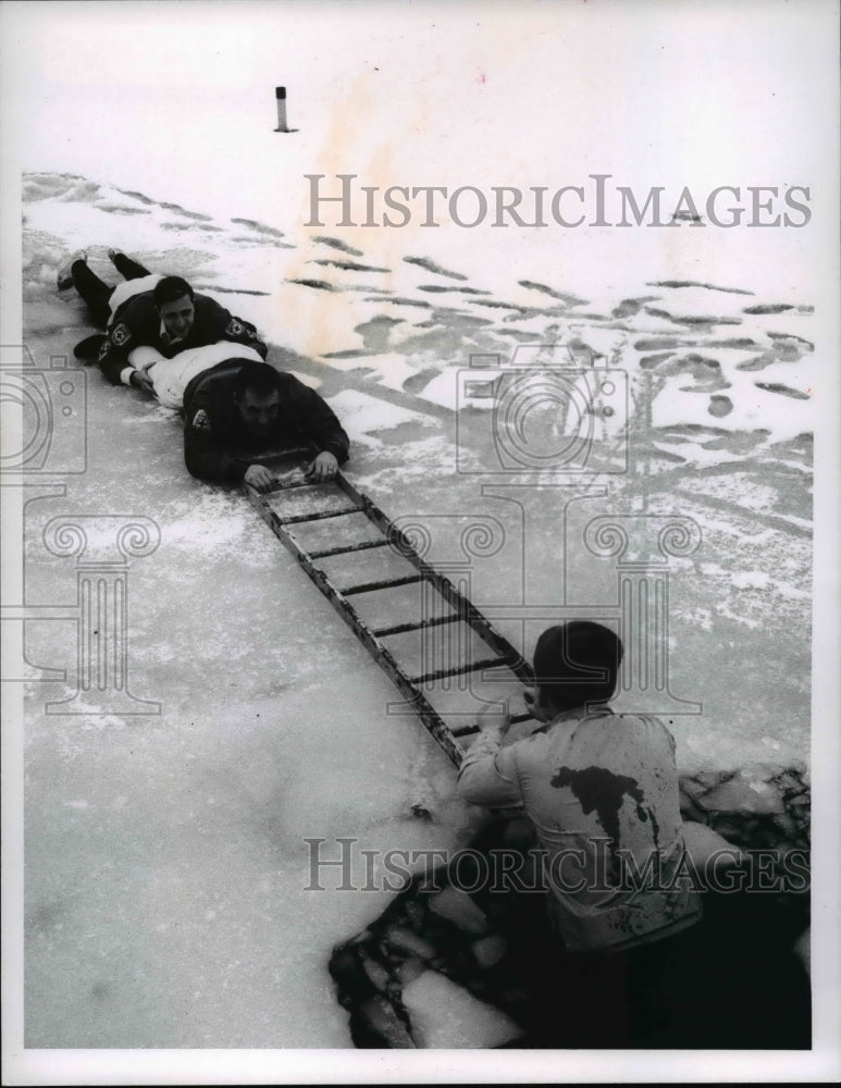 Load image into Gallery viewer, 1967 Press Photo Victim John Norris rescued by d Suit &amp; Andy Lieber
