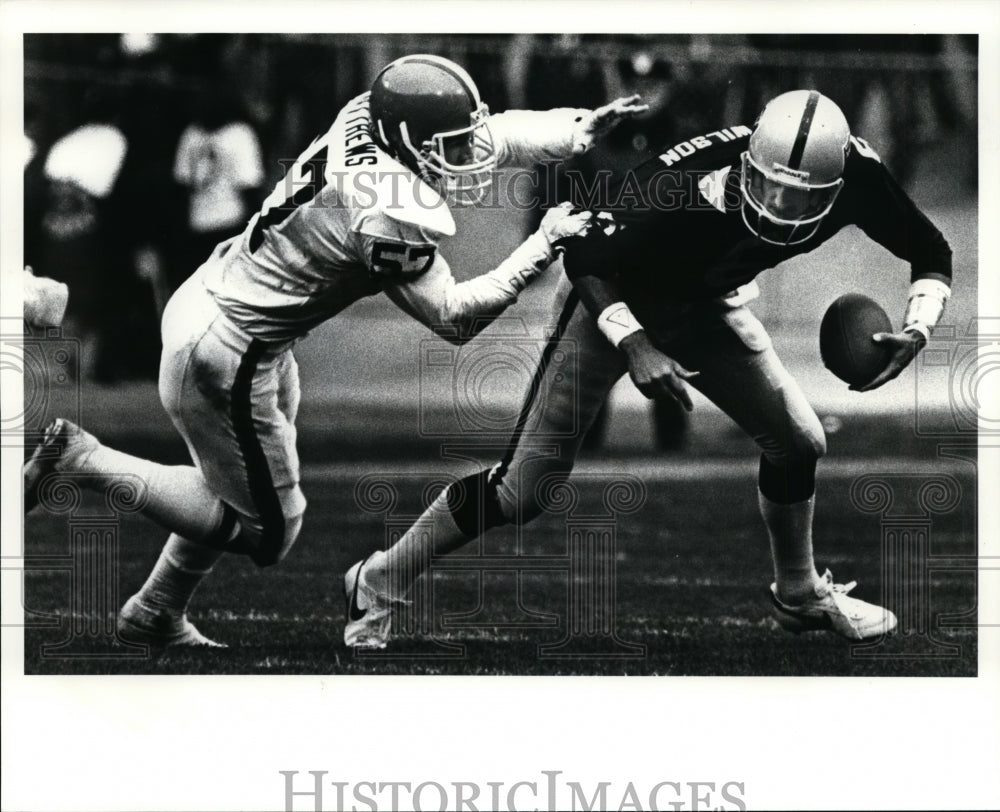 1985 Press Photo Wilson is sacked by Clay Matthews-football game - cvb33955- Historic Images