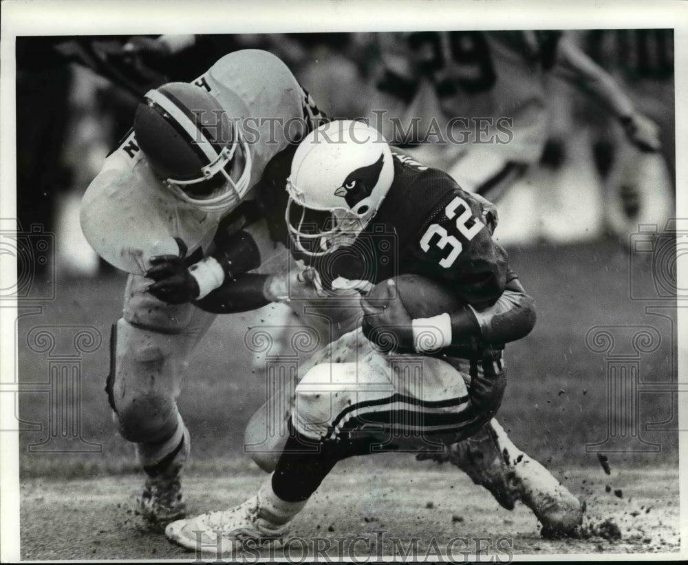 1985 Press Photo Carl Hariston grabs Otis Anderson behind the line for a 3yrd.- Historic Images