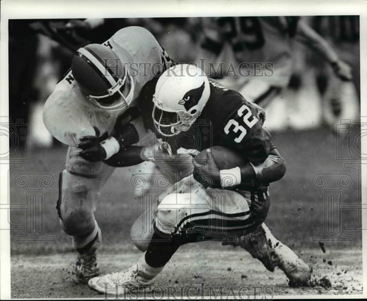 1985 Press Photo Carl Hariston grabs Otis Anderson behind the line for a 3yrd.- Historic Images