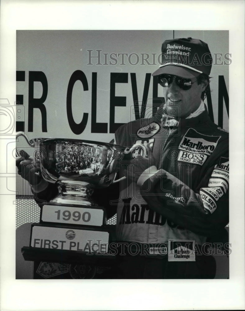 1990 Press Photo Danny Sullivan holds trophy on victory stand - cvb44991- Historic Images