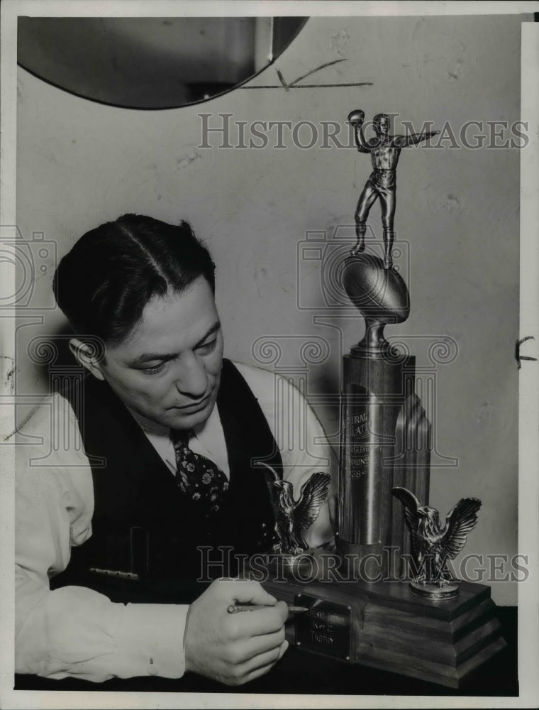 1938 Press Photo Rickey Tanno-finishing touches on football trophy - cvb48743- Historic Images