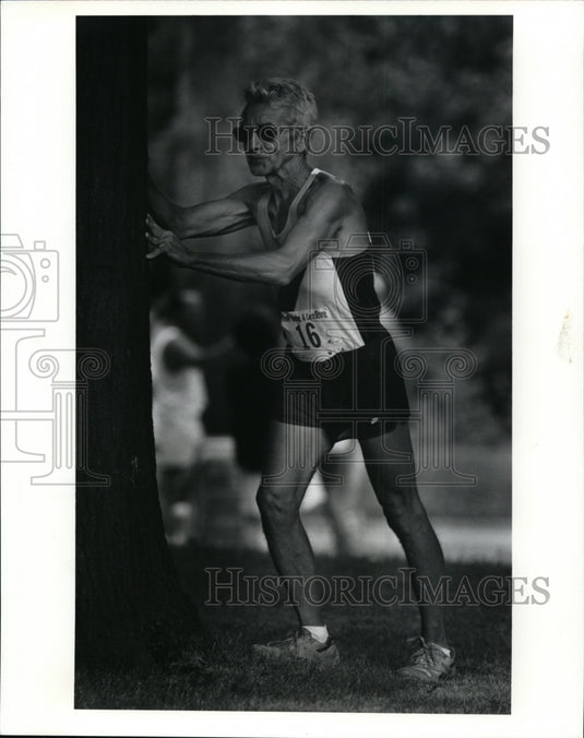 Press PhotoBob Adams, 61, Lorain, stretches before the Beaumont Blue Streak Run- Historic Images