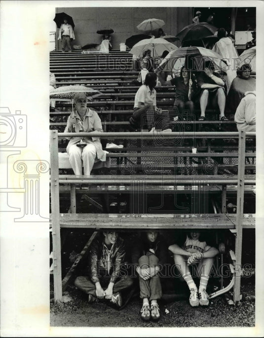 1981 Press Photo Three track runners take shelter between events - cvb52770- Historic Images