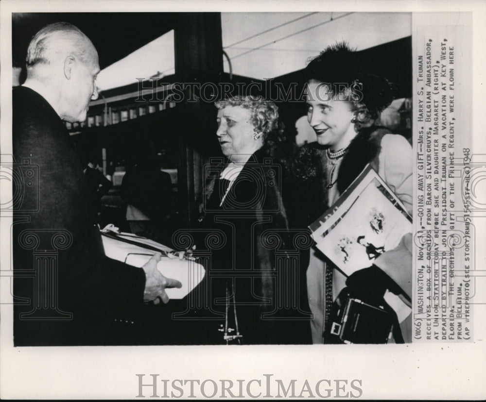 1948 Press Photo Mrs. Harry Truman receives a box of Orchids from Ambassador.- Historic Images