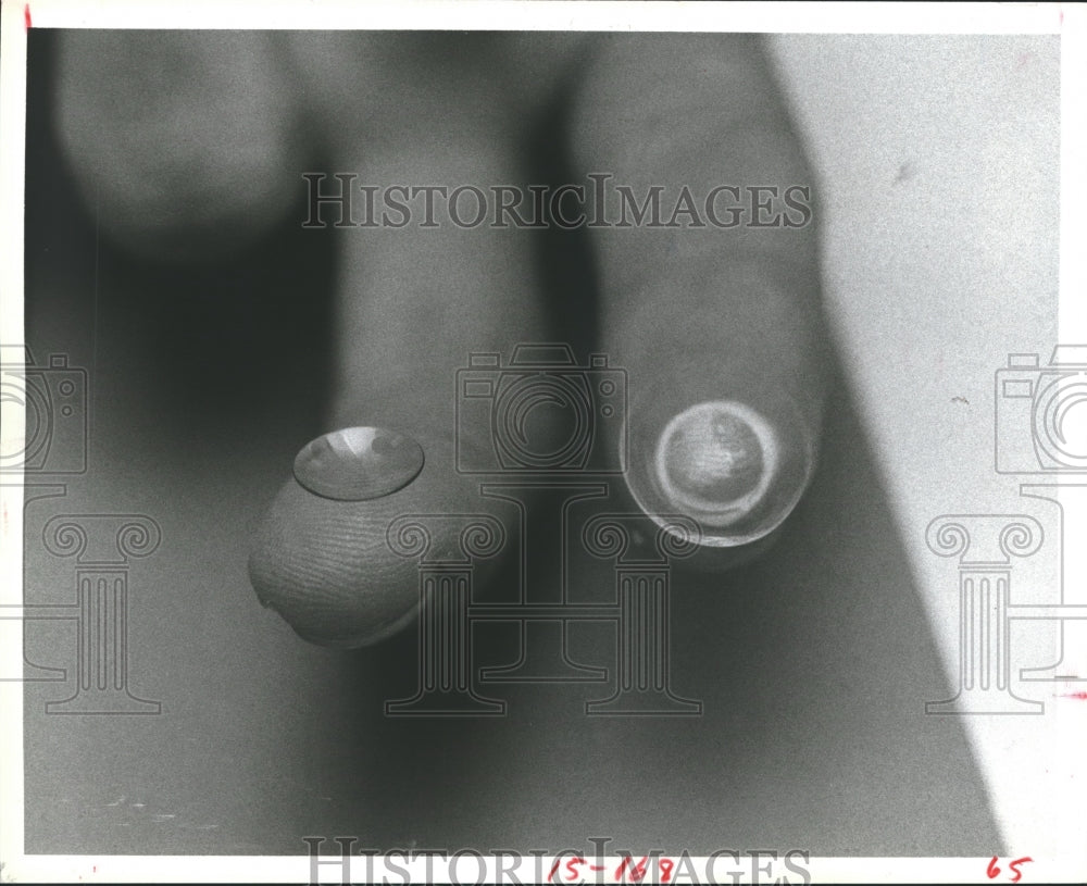 1983 Press Photo Doctor Showing A Hard and A Soft Contact Lens. - hca13411- Historic Images