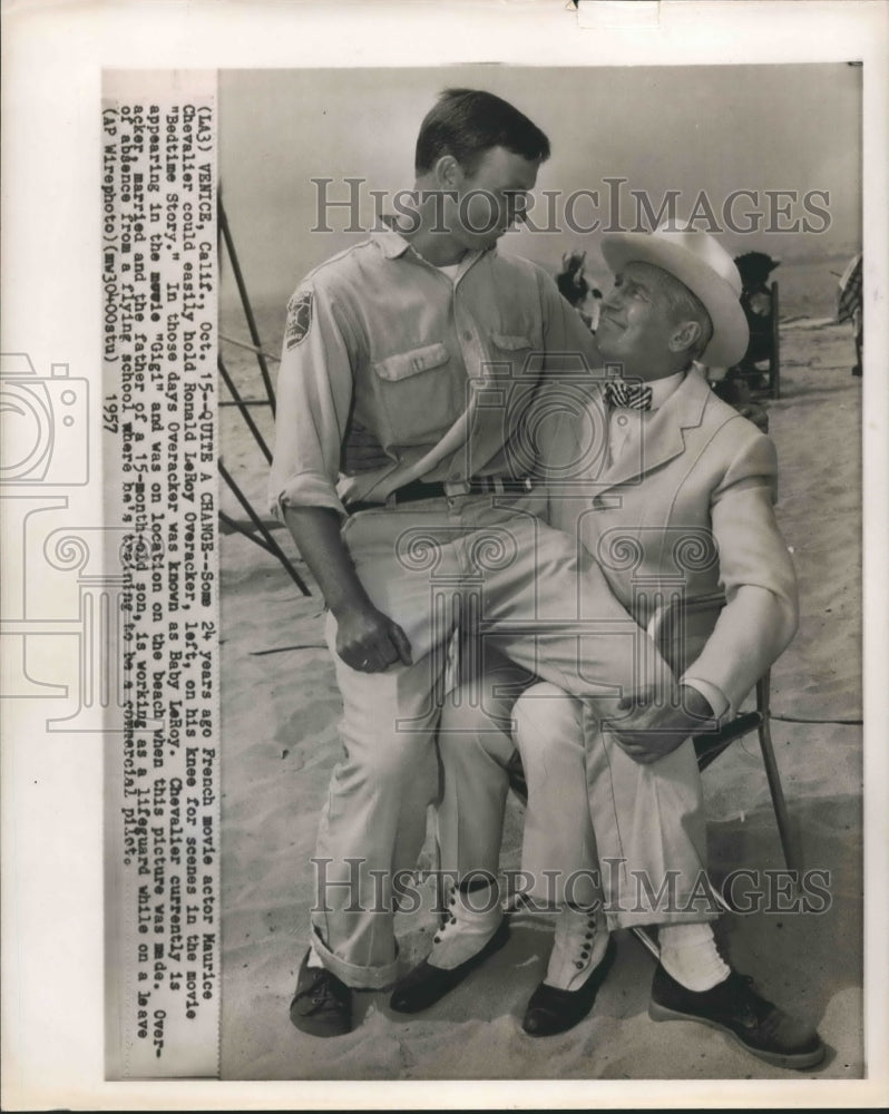 1957 Press Photo Ronald LeRoy Overacker on lap of actor Maurice Chevalier- Historic Images