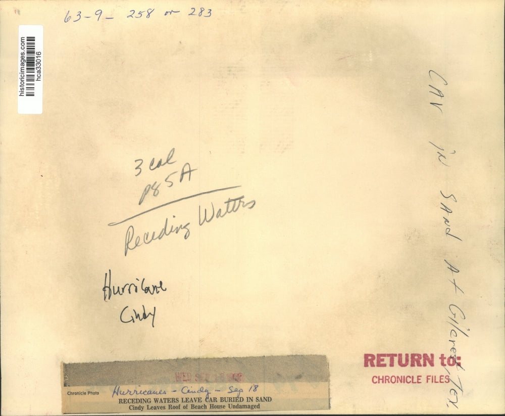 1962 Press Photo Hurricane Cindy leaves car buried in the sand in Texas