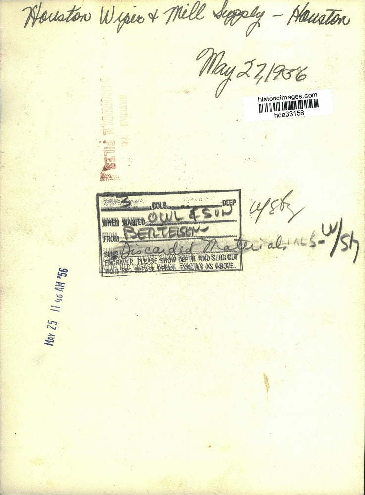 1956 Press Photo Men sort through material pile at Houston Wiper & Mill Supply