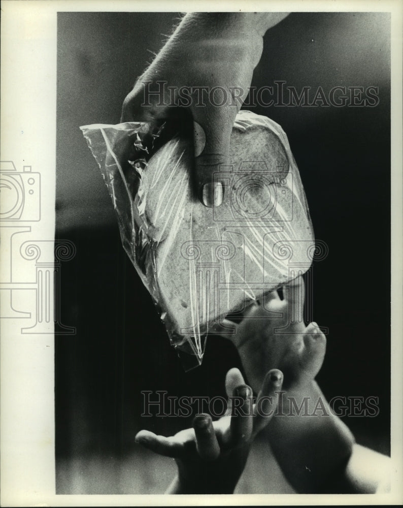 1968 Press Photo Tiny hands reach for sandwich during hurricane, Port Lavaca, TX