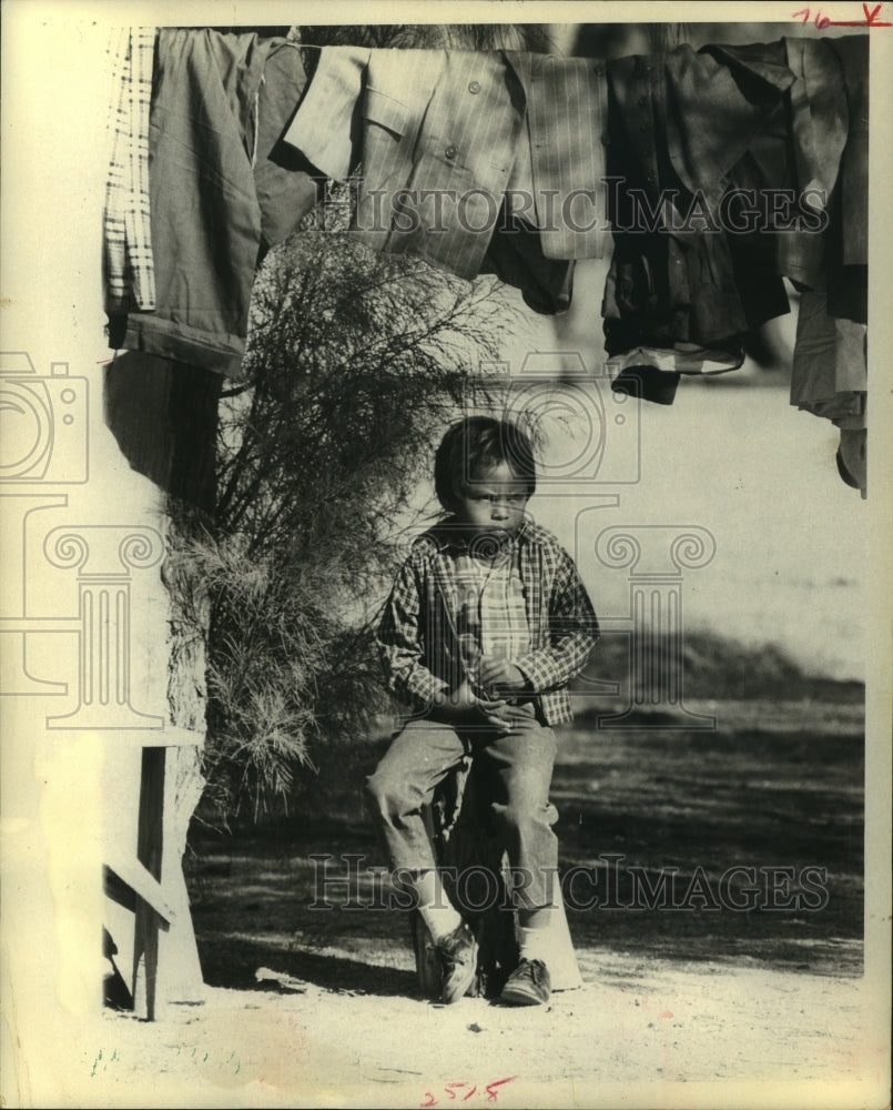 1970 Press Photo Young Native American boy sits on stool and glowers - hca40848